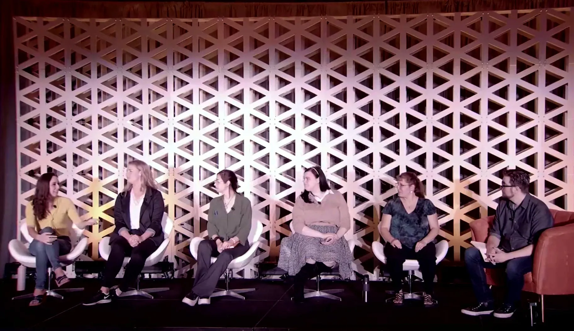 The WattCon 2022 world-building panel: six writers seated on stage, Erica at the far left